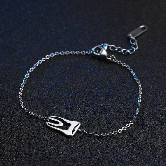 Dentist tooth charm bracelet worn on a wrist