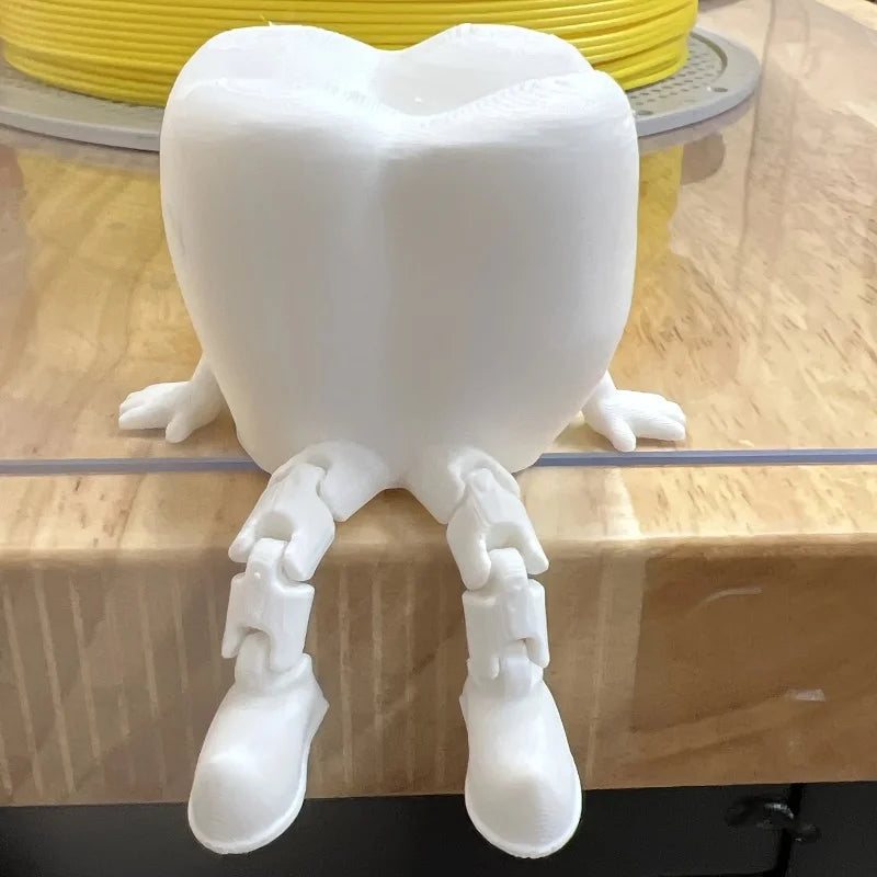 3D printed teeth desk ornament on a shelf